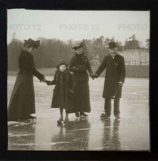 Magic lantern slide well-dressed middle class Edwardian family ice skating England, UK c 1900-1910