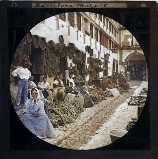 'Espartería en Almería' 1890 photographers Hermenegildo Otero and Miguel Aguirre, circular magic lantern slide mis-captioned as Barcelona, Spain. Women basket weavers and rope makers sitting in market place. Thought to be Cordoba