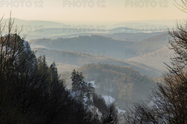 View over the hills and valleys from the mountain with hoarfrost on the branches in winter, Vápec, Horná Poruba, Slovakia