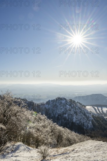 View over the hills and valleys from the mountain with hoarfrost on the branches in winter, Vápec, Horná Poruba, Slovakia