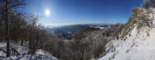 View over the hills and valleys from the mountain with hoarfrost on the branches in winter, Vápec, Horná Poruba, Slovakia