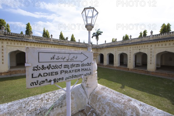 Signpost in the gumbaz or mausoleum of Tipu Sultan and his family, Srirangapatna, Karnataka, India