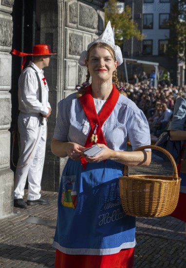 Woman in traditional Dutch dress with basket on sunny day, cheese market, Alkmaar, Alkmar, Noord-Holland, North Holland, Netherlands