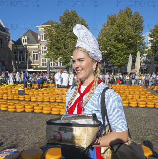 Woman in traditional dress at a sunny cheese market, Cheese, Cheese market, Alkmaar, Alkmar, Noord-Holland, Noord-Holland, Netherlands