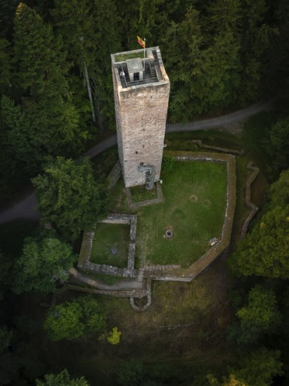 A tower and surrounding ruins hide in the middle of dense forests, seen from above, Mandelberg castle ruins, Pfalzgrafenweiler, Germany
