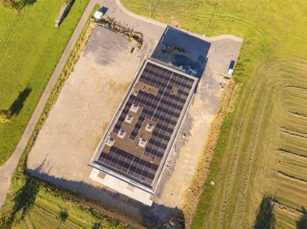 Top view of solar roof of a building with surrounding fields and car park, new building with green roof and PV system, Wiernsheim, Germany