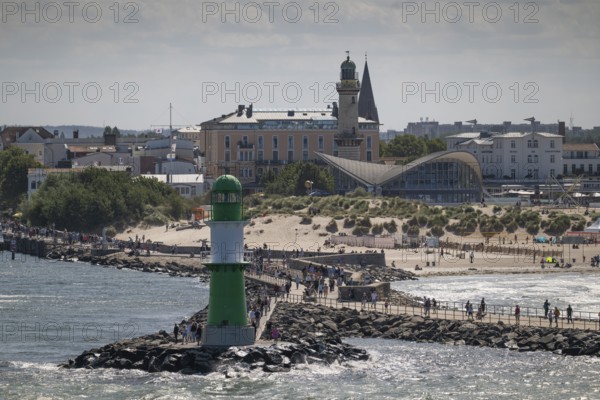 Green-white lighthouse, pier light Westmole, hotels in the background, Warnemünde, Rostock, Mecklenburg-Western Pomerania, Germany