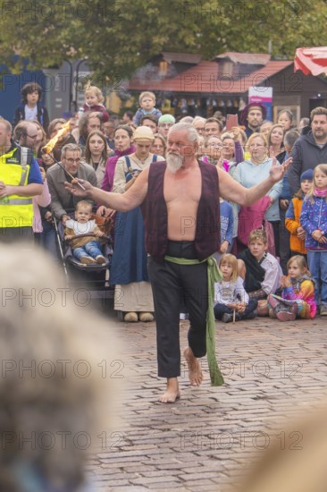 An experienced fire artist shows his art to a fascinated audience, Feuernacht, Sindelfingen, Germany