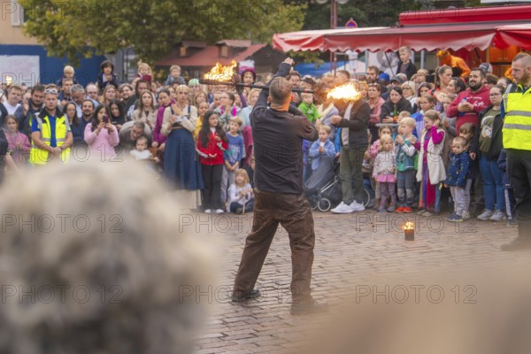 A fire juggler fascinates the audience with his art in a lively setting, Feuernacht, Sindelfingen, Germany