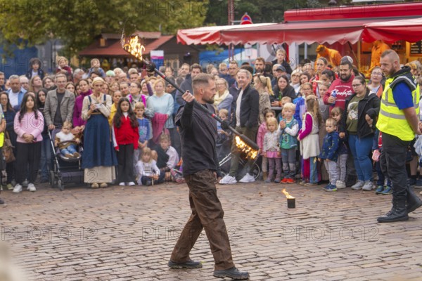 A fire juggler impresses the audience with his tricks on a busy square, Feuernacht, Sindelfingen, Germany