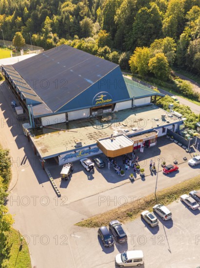 Close-up of an entrance area with car park, surrounded by forest, sunny surroundings, Polarion Ice Stadium, Bad Liebenzell, Black Forest, Germany