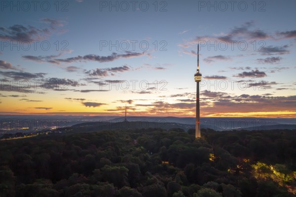 Television tower at dusk over forest and under dramatic sky, Stuttgart-Degerloch, Baden-Württemberg, Germany