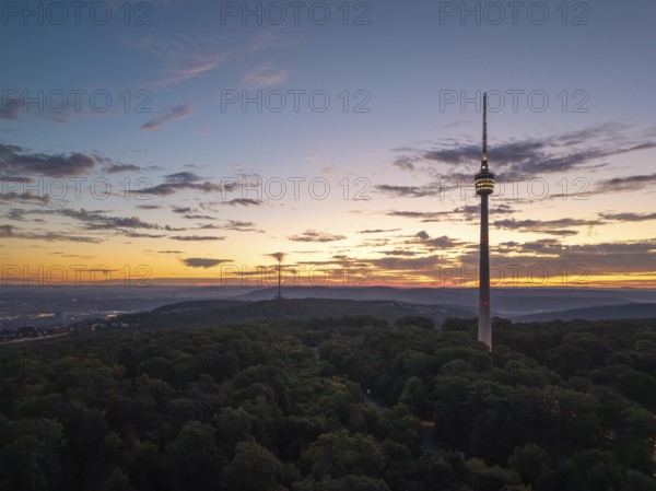 Television tower with rising light over a wooded horizon, Stuttgart-Degerloch, Baden-Württemberg, Germany