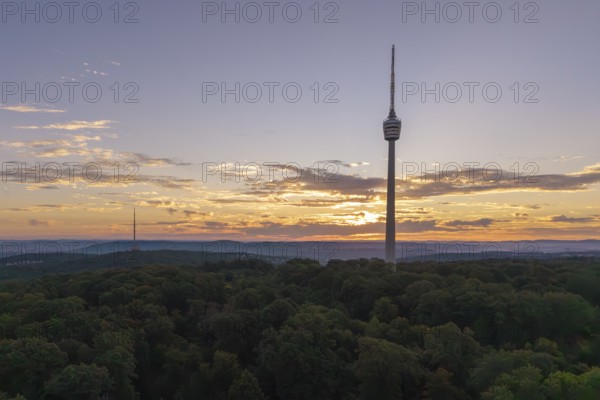 Sunrise behind a television tower in the forest with clouds in the sky, Stuttgart-Degerloch, Baden-Württemberg, Germany