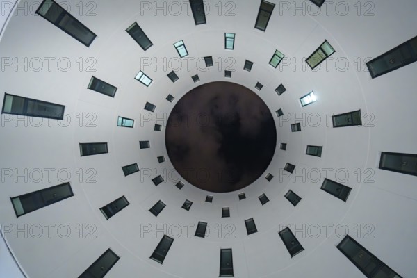 View upwards to circularly arranged windows in a modern building, Munich, Germany