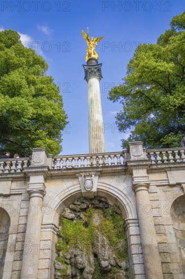 A magnificent golden statue on a column above a staircase, Munich, Germany