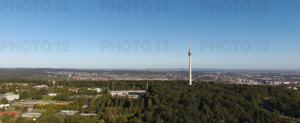 Panoramic view of a cityscape dominated by a television tower and surrounded by dense forests under a clear sky, Gazi Stadium, Stuttgart-Degerloch, Baden-Württemberg, Germany