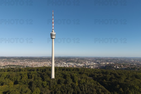 Television tower rises above a wooded area against an urban backdrop, Stuttgart, Baden-Württemberg, Germany