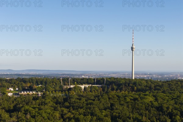 Stuttgart television tower rises above a forest with an urban backdrop on the horizon, Gazi Stadium, Stuttgart, Baden-Württemberg, Germany