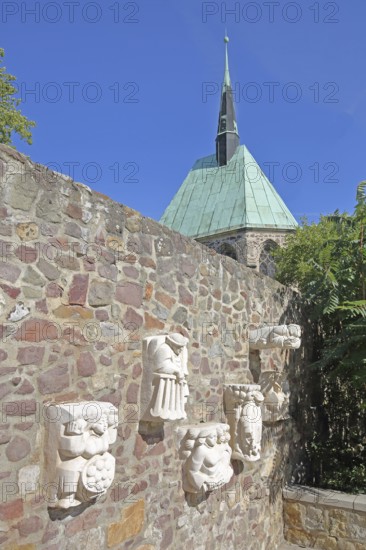 Sculptures of Magdeburg originals on the city wall and the Gothic Magdalen Chapel, Magdeburg, Saxony-Anhalt, Germany