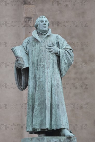 Luther monument, Martin Luther with Bible, sculpture, verdigris inscription, monument, Magdeburg, Saxony-Anhalt, Germany