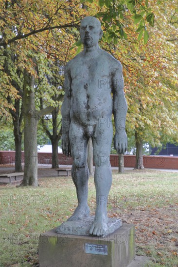Sculpture Large striding man by Wieland Förster 1969, bronze sculpture, nude male figure, walking, life-size, sculpture park, Magdeburg, Saxony-Anhalt, Germany