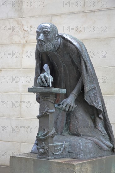 Albertus Magnus by Heinrich Apel 1985, medieval scholar and bishop writing with quill, view, bronze sculpture, monument, Magnus monument, St Peter's, Magdeburg, Saxony-Anhalt, Germany