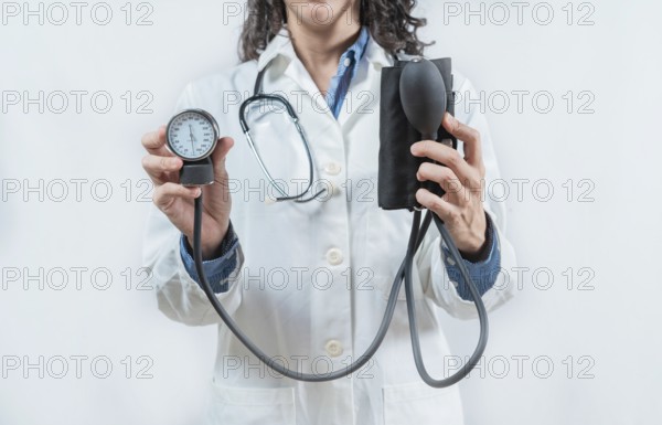 Doctor hands showing blood pressure monitor isolated. Close up of Doctor showing tensiometer isolated