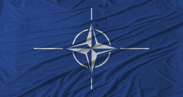 NATO flag waving. Flag of NATO with cloth texture
