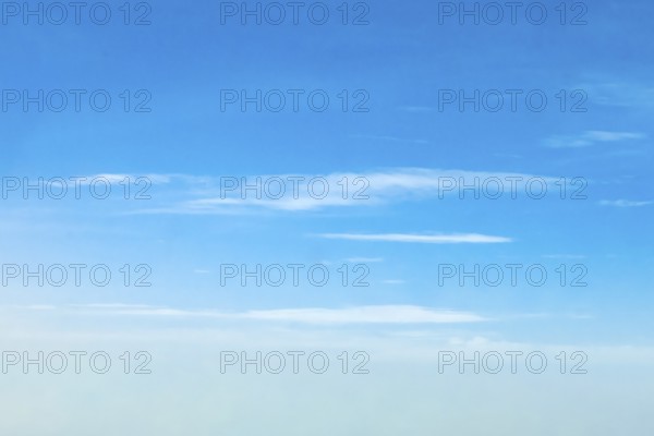 Altostratus clouds at an altitude of around six 6 kilometres under a blue sky, international