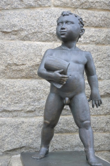 Putti at the town hall, bronze sculpture, naked figure with scroll, paper, entrance, town hall, Aschersleben, Harz, Saxony-Anhalt, Germany