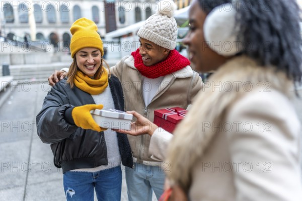 Happy multi ethnic friends joyfully exchanging christmas gifts in a bustling city, celebrating the warmth of friendship during wintertime
