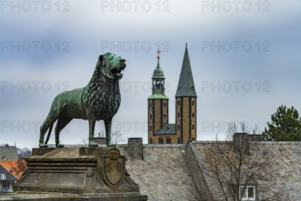 Brunswick Lion of the Imperial Palace and the towers of the Market Church of St Cosmas and Damian in Goslar, Lower Saxony, Germany