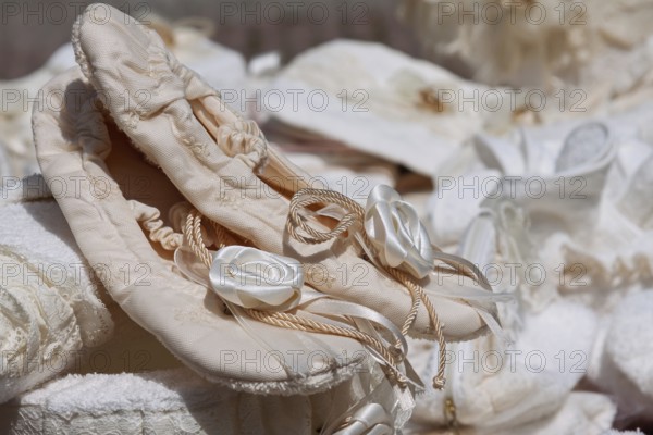 Satin ballet shoes with floral embellishment, embedded in a soft, romantic atmosphere, weekly market market, Tuscany, Italy