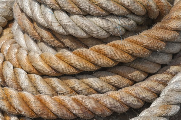 Close-up of several twisted ropes in shades of beige and brown with a clear texture, East Frisia, Lower Saxony, Germany
