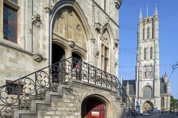 13th century Gothic St Bavo's Cathedral and entrance to the 14th century medieval belfry in the historic city centre of Ghent, East Flanders, Belgium