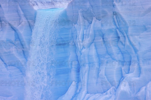 Waterfall at edge of the Brasvellbreen glacier from the ice cap Austfonna pouring into the Barents Sea, Nordaustlandet, Svalbard, Spitsbergen