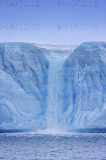 Waterfall at edge of the Brasvellbreen glacier from the ice cap Austfonna debouching into the Barents Sea, Nordaustlandet, Svalbard, Spitsbergen