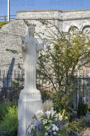 Hawthorn bush and statue of Virgin Mary in front of bridge at Our Lady of Beauraing, Notre-Dame de Beauraing sanctuary, province of Namur, Belgium