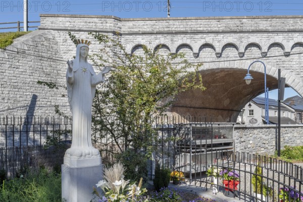 Hawthorn bush and statue of Virgin Mary in front of bridge at Our Lady of Beauraing, Notre-Dame de Beauraing sanctuary, province of Namur, Belgium