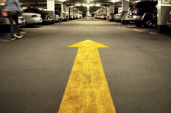 Yellow arrow in a car park in Manhattan, New York City, USA