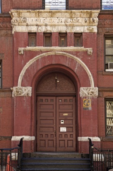 Historic school building with separate school entrance for boys, New York City, USA
