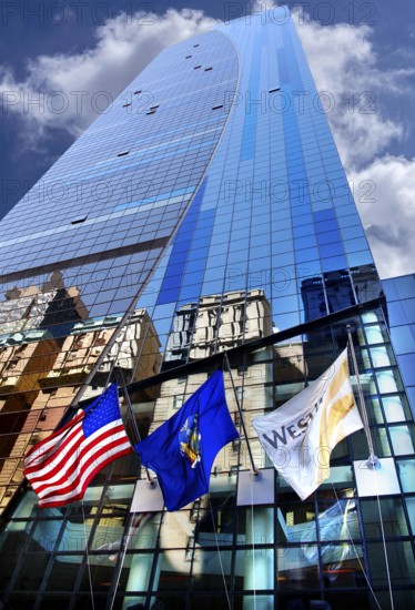 Skyscraper façade with flags and reflection in the glass façade, New York City, USA