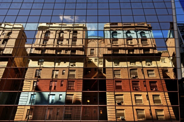 Residential buildings reflected in a high-rise façade, New York City, USA