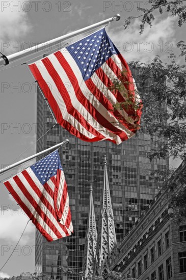Waving USA flags, behind towers of St Patrick's Cathedral, Manhattan, New York City, USA