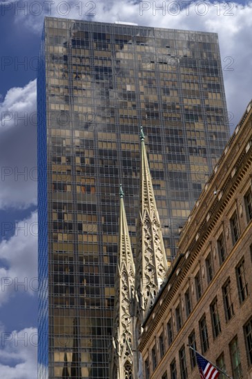 Towers of St Patrick's Cathedral in front of a skyscraper, Manhattan, New York City, USA
