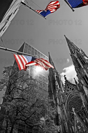Towers of St Patrick's Cathedral in front of skyscrapers, waving USA flags, New York City, USA