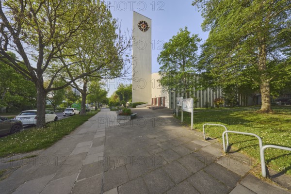 Ev. Stephanuskirche Weilimdorf gable, church, modern architecture, architect Wilhelm Tiedje, church tower, tower clock, pavement, parking lane with vehicles, trees, lawn, evening light, blue sky, cloudless, Giebelstraße, Stuttgart, state capital, city district Stuttgart, Baden-Württemberg, Germany