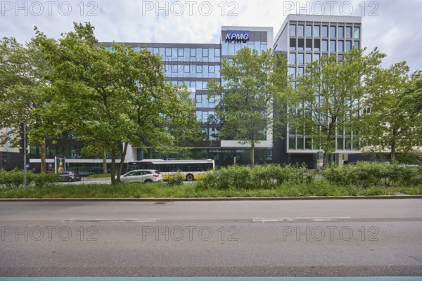 Auditing and management consultancy KPMG, modern architecture, street, public bus, trees, milky blue sky, diffuse light, Theodor-Heuss-Straße, Stuttgart, state capital, urban district of Stuttgart, Baden-Württemberg, Germany