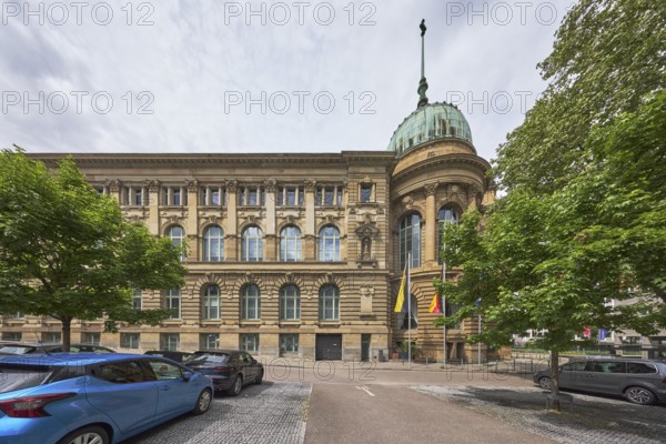 Haus der Wirtschaft Baden-Württemberg, conference centre, congress centre, historic building, architect Frederik Skjøld Neckelmann, street, car park, vehicles, flag, flagpoles, trees, milky blue sky, diffuse light, slightly sunny, Willi-Bleicher-Straße, Stuttgart, state capital, urban district of Stuttgart, Baden-Württemberg, Germany